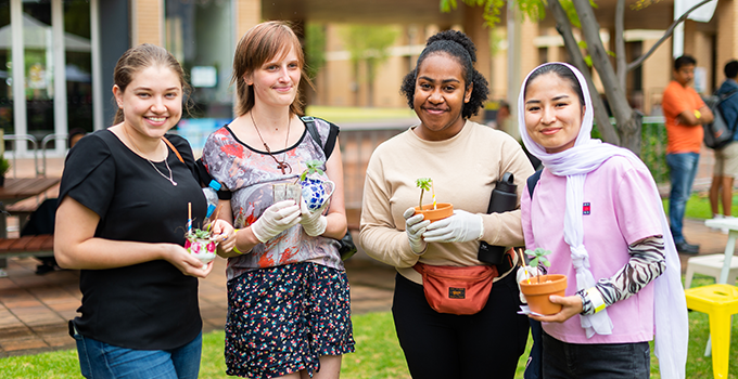 Image of students with potted plants