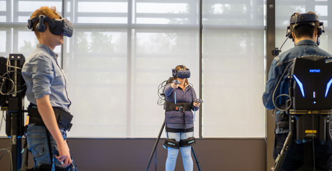 Image of three people using the VR equipment