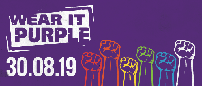 Wear It Purple Day logo 30 August 2019 rainbow-coloured row of fists