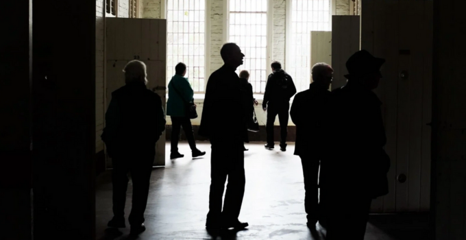 Image of silhouette of people in an old hospital ward