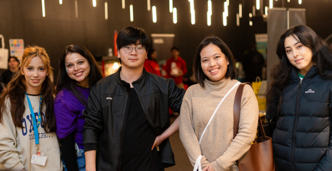 Group of smiling students during an event in the City West Student Lounge.
