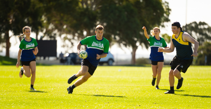 Image of UniSA students playing in mixed rugby game