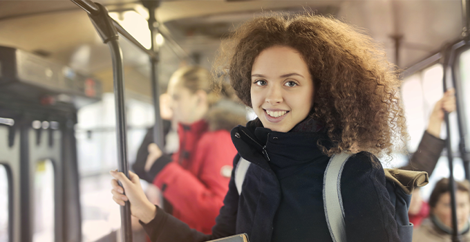 Image of female student taking public transport.