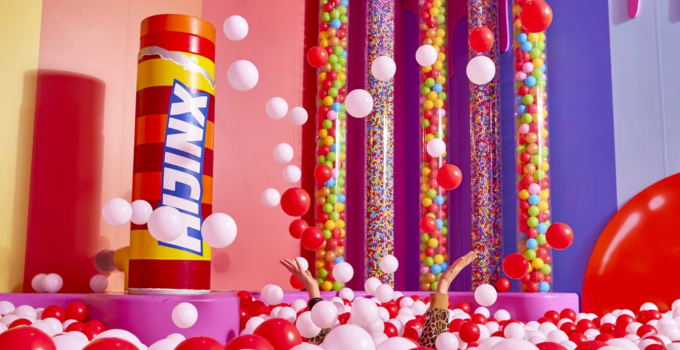Hijinx Hotel Adore A Ball Pool room filled with red and white balls and multicoloured walls.