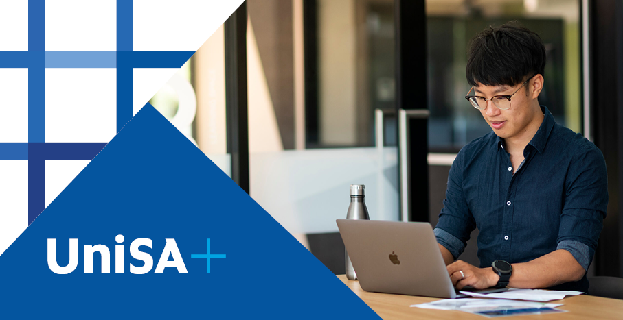 UniSA+ branded banner with photograph of male student working on laptop.