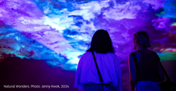 Two female friends viewing cloud light display at Natural Wonders exhibition
