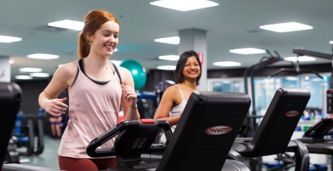 Image of two women running on treadmills at the Pridham Hall gym