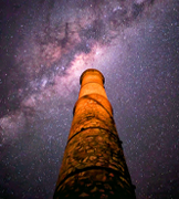 Large stone chimney with a purple starry night sky in the background.