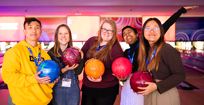 Photo of happy students at a bowling alley.