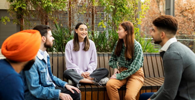 Image of male and female students having a conversation in the Plaza at City East