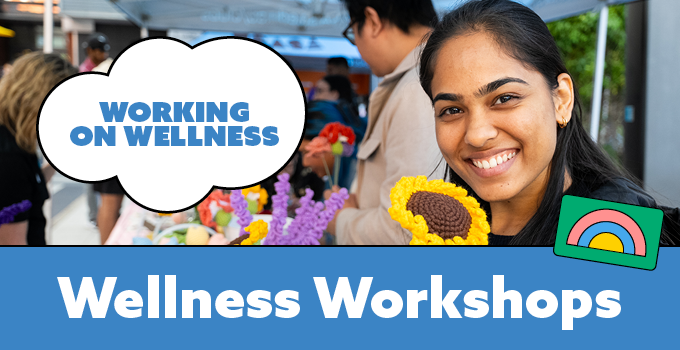 Photo of happy student at a USASA market stall with crochet flowers. Banner text reads: 'Working on Wellness. Wellness Workshops.'