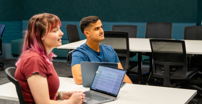 Photos of two students engaging in class discussions in a tutorial room